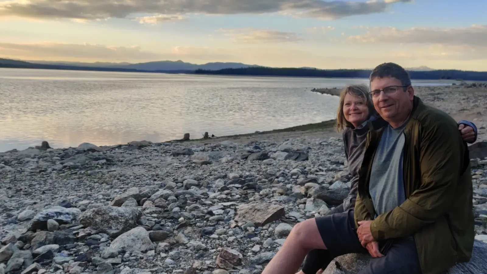 Person in red kayak on river and calm water with slight ripples in Grand Teton National Park.