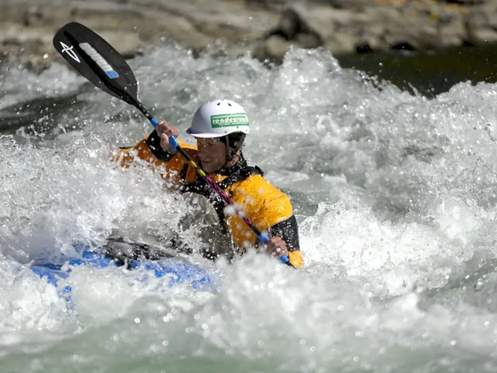 Person in red kayak and whitewater rapids in Jackson Hole.