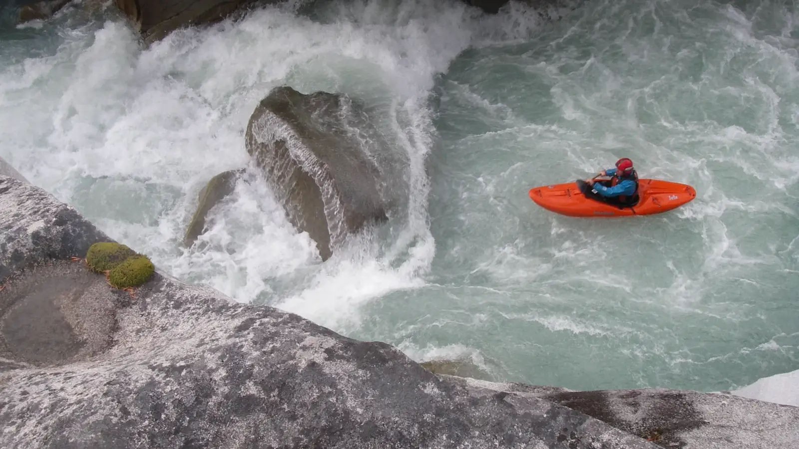 One person in orange kayak and whitewater rapids in Jackson Hole.