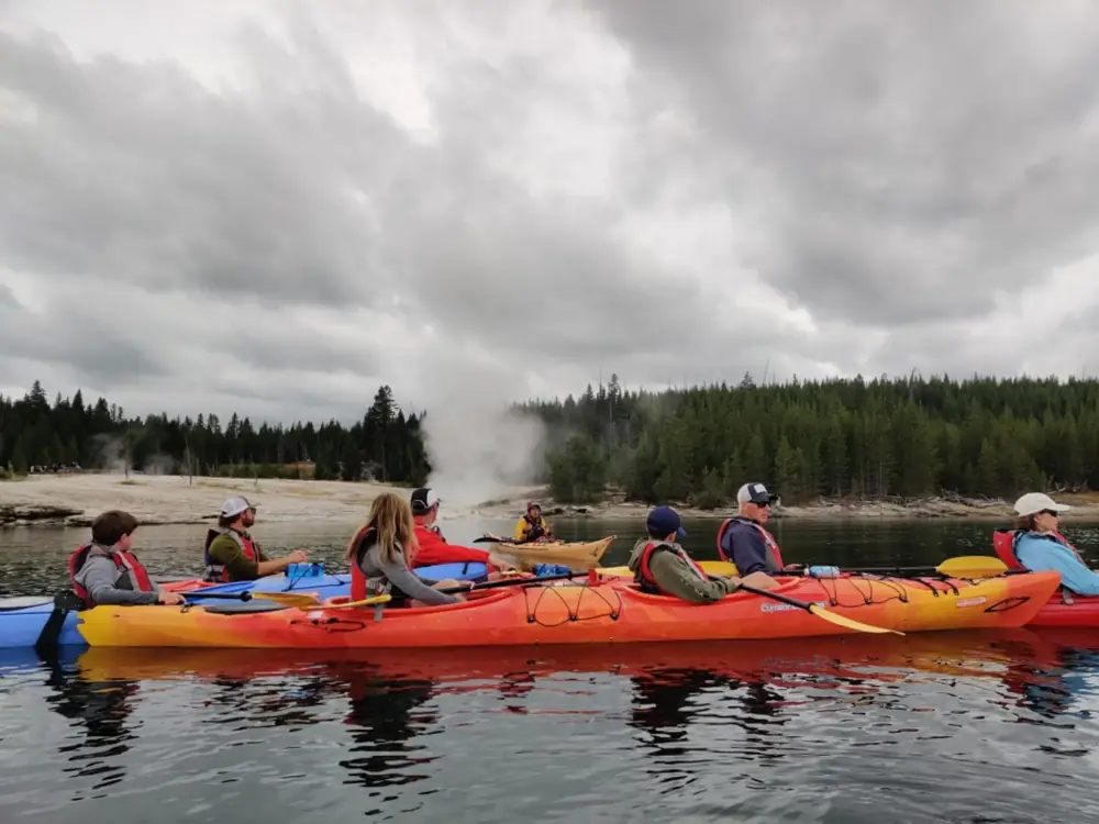 Person in red kayak and whitewater rapids in Grand Teton National Park.