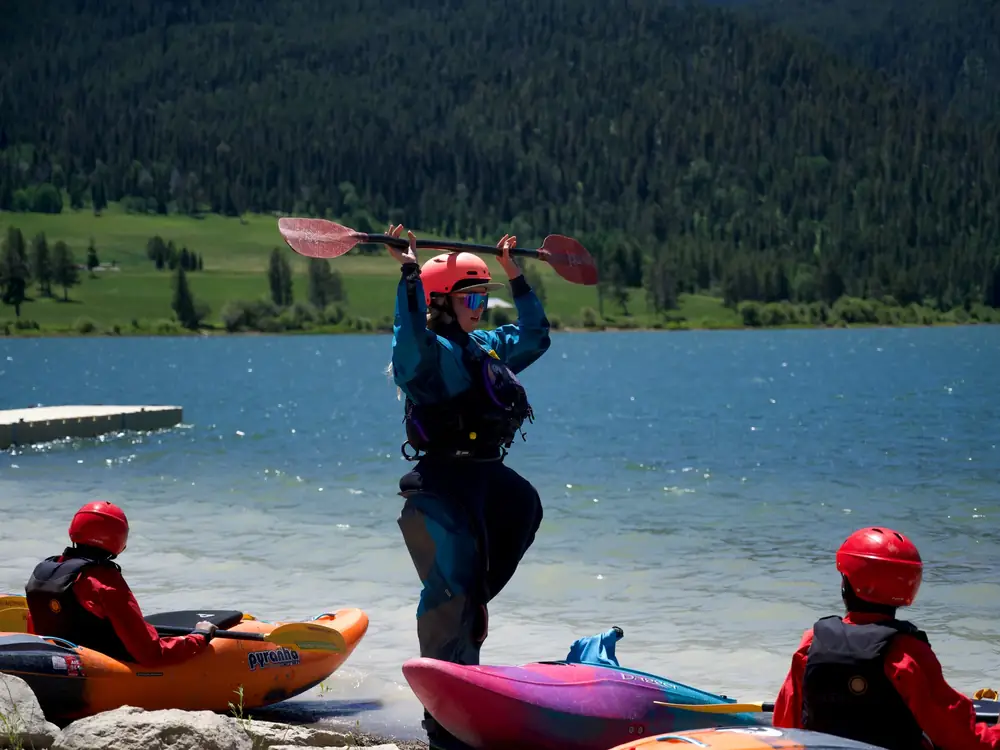 Lake with small waves and rocky shoreline in foreground in Jackson Hole.