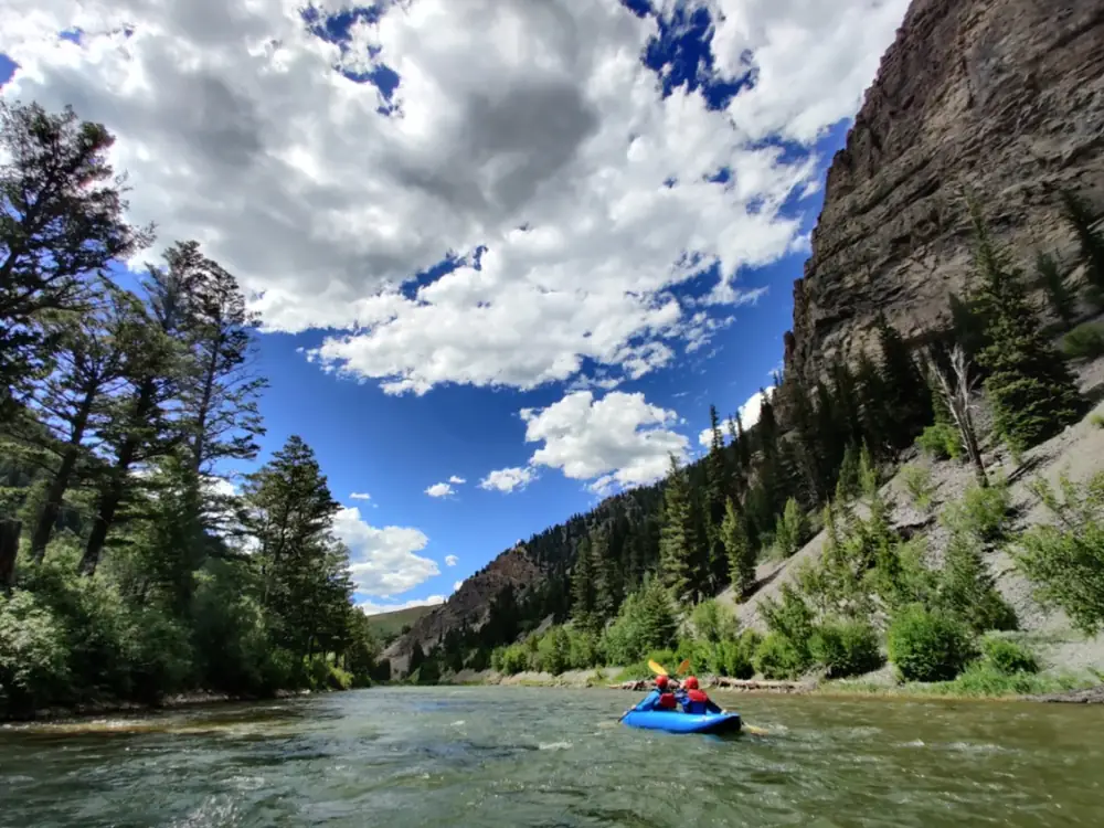 Inflatable kayakers navigating whitewater rapids on the Snake River