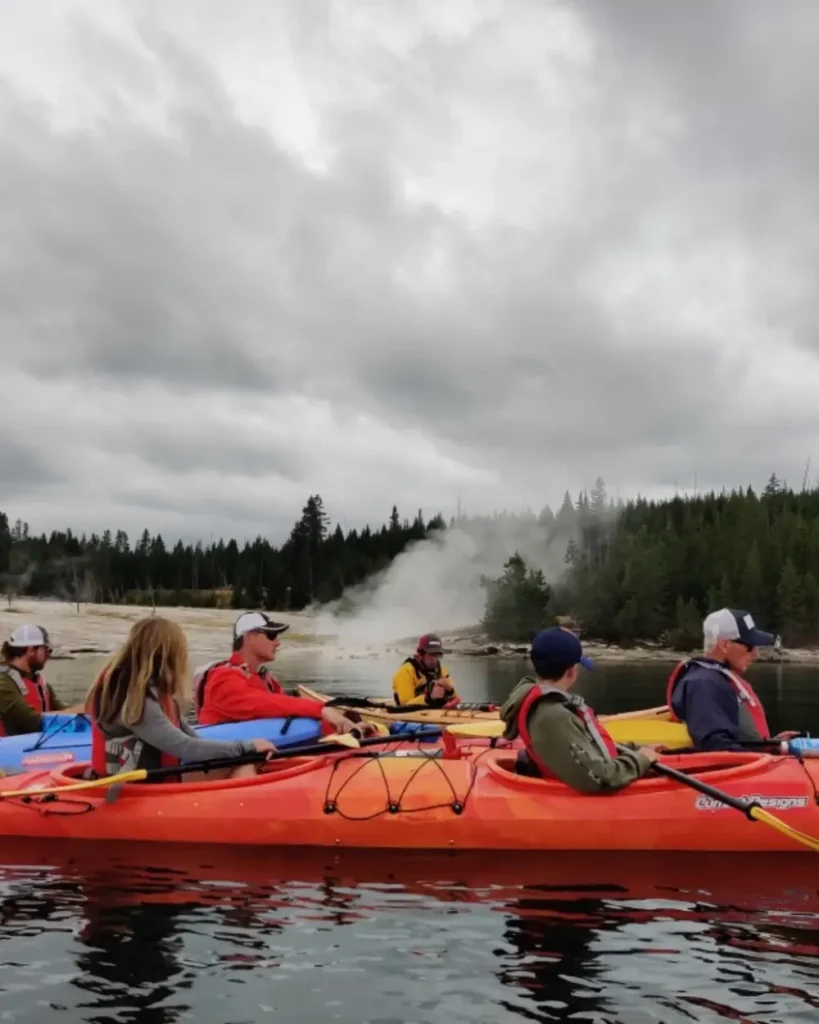 Person in yellow kayak and calm river water in Snake River.