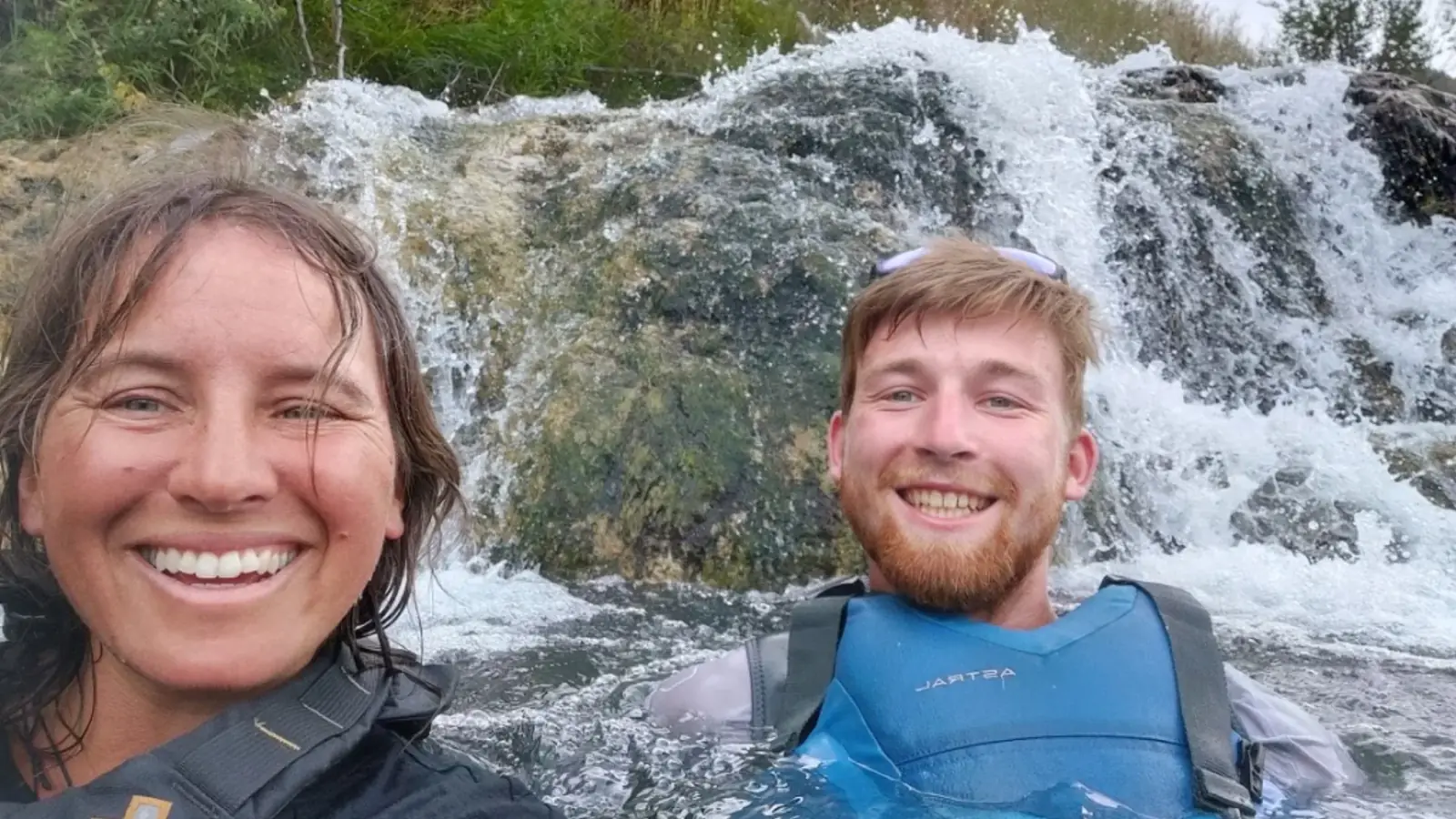 Person in yellow kayak and river with rapids and white water in Snake River.