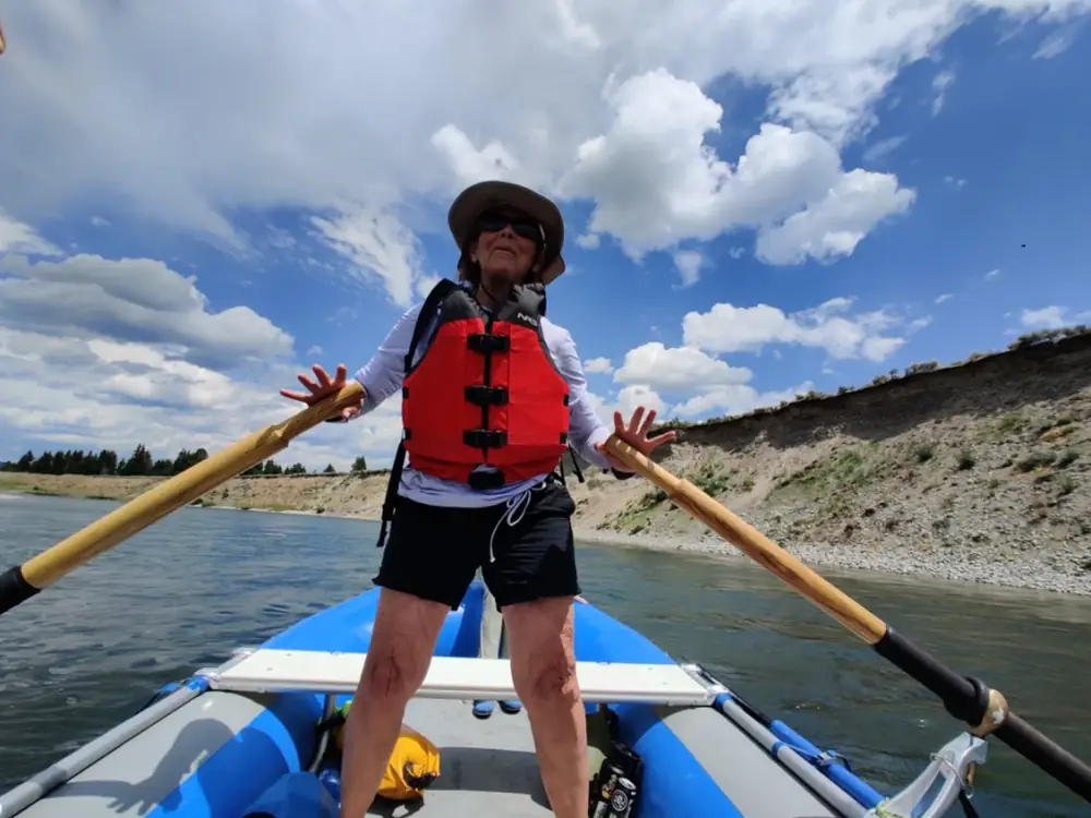 Person in white kayak and white water rapids in Snake River.