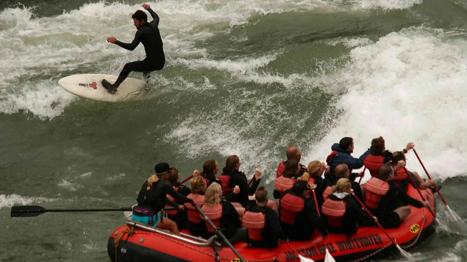 Single person in red kayak and whitewater rapids in Jackson Hole.