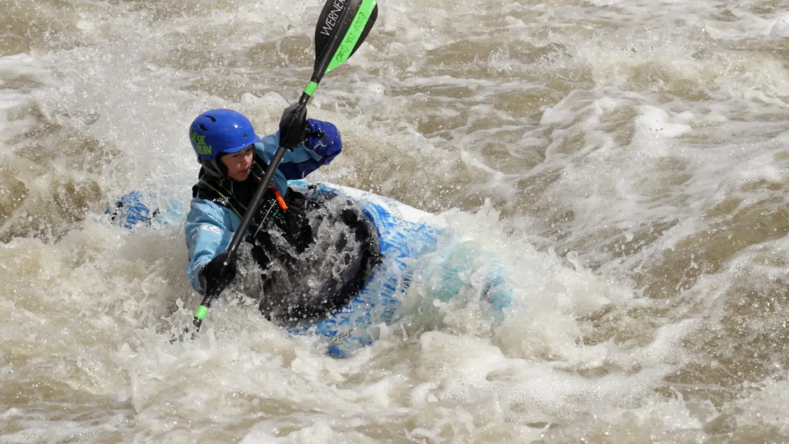 One person in a kayak and blue helmet in Jackson Hole.