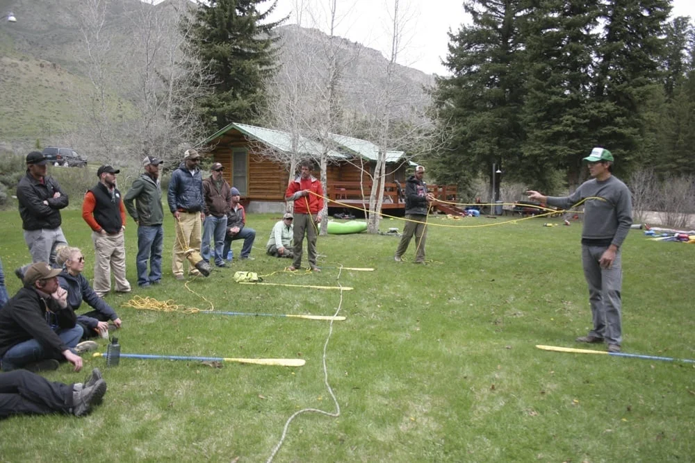 Instructors and students in a riverside classroom session along the Hoback River.