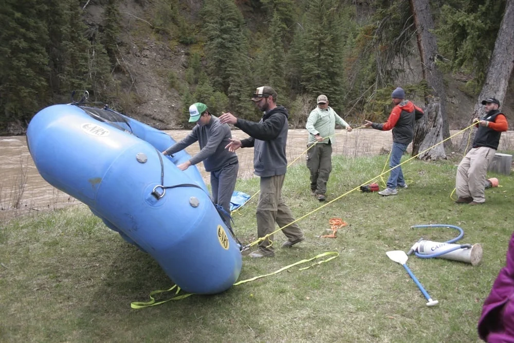 Students practicing with rope systems during a swiftwater rescue training course.