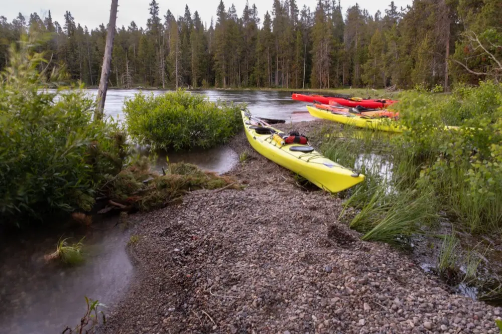 Kayaks beached in a sheltered cove at Spalding Bay campsite on Jackson Lake.